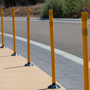 Yellow Omniflex delineators with rebound base lining roadway for high-visibility lane control in traffic and construction zones.