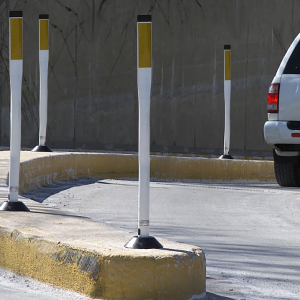 Flat top Omniflex delineator installed on raised curb at highway off-ramp for visible traffic control in roadway settings.