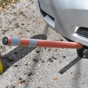Omniflex delineator bending and rebounding upright after vehicle impact to show durability and flexibility in traffic control.
